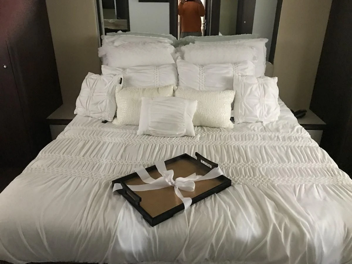 a bed with white sheets and pillows aboard NEXT Yacht for Sale