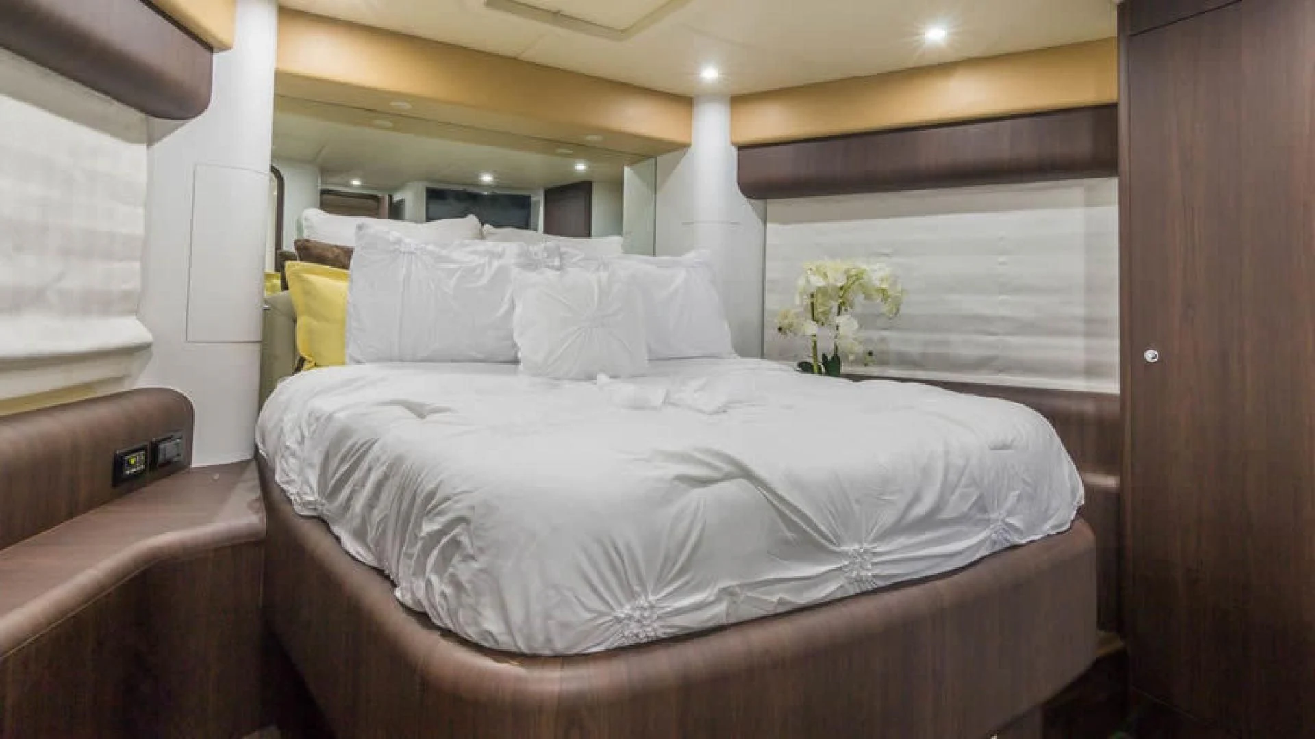 a bed with white sheets and pillows aboard NEXT Yacht for Sale