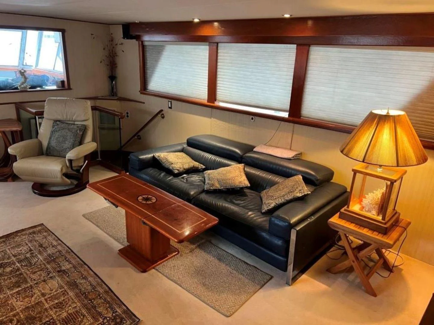 a living room with a leather couch aboard MISS WENDY Yacht for Sale