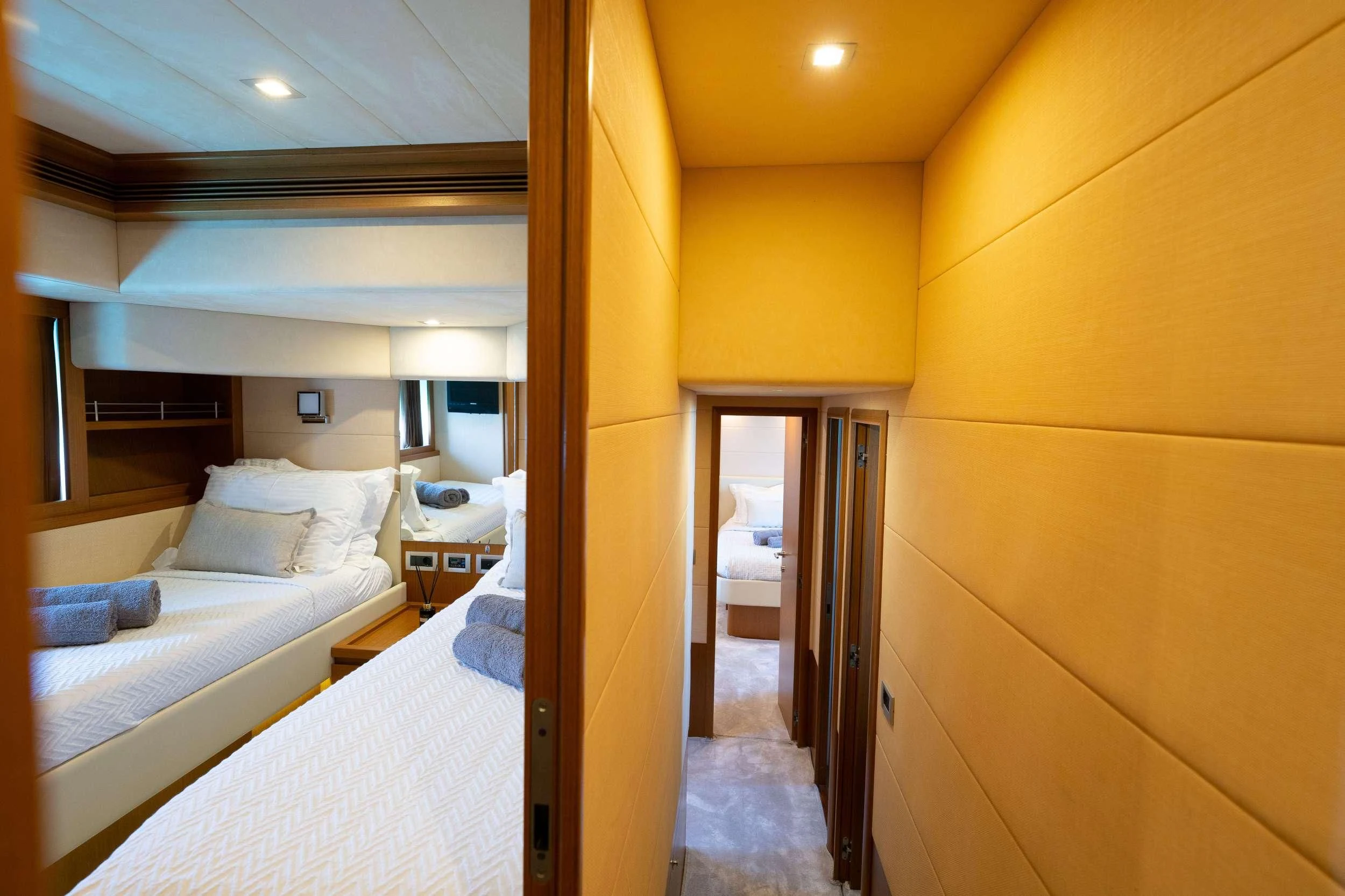 a room with a bed and a door aboard NINETEEN Yacht for Charter