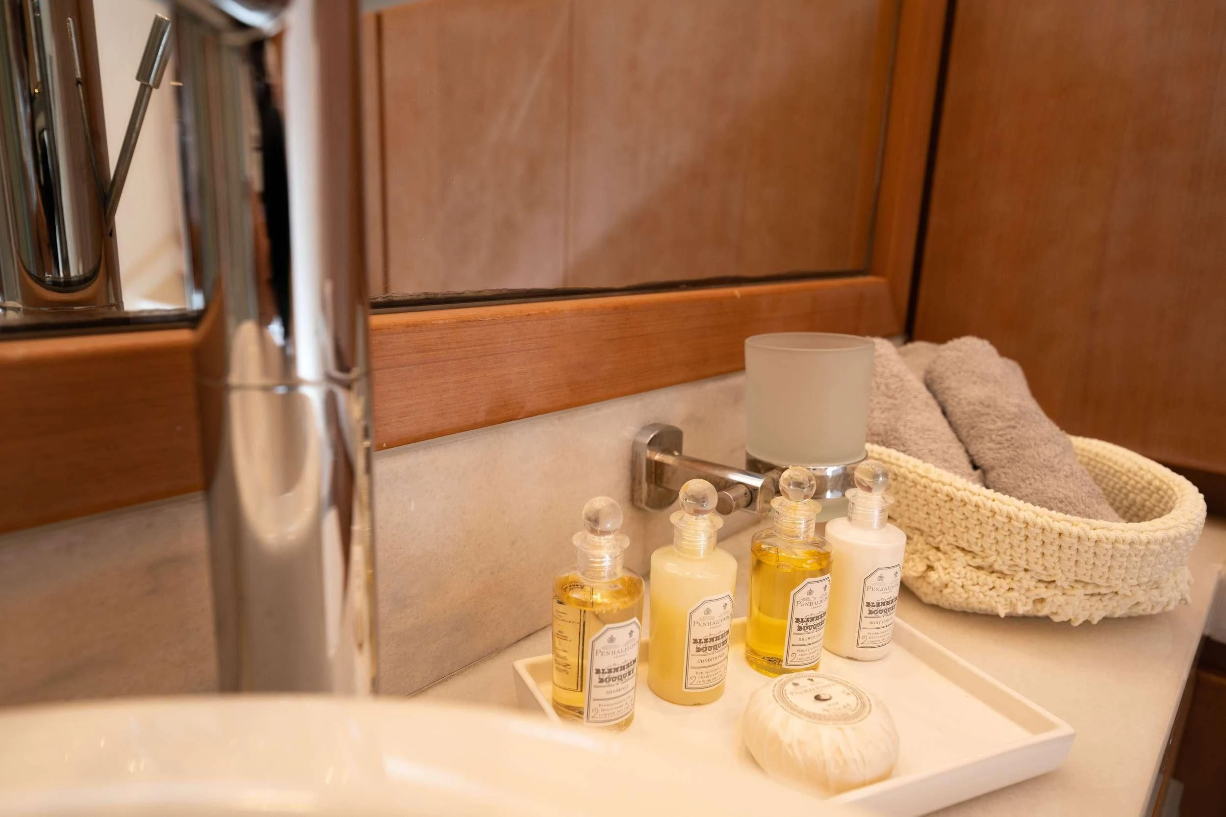 a bathroom sink with a towel and toiletries aboard NINETEEN Yacht for Charter