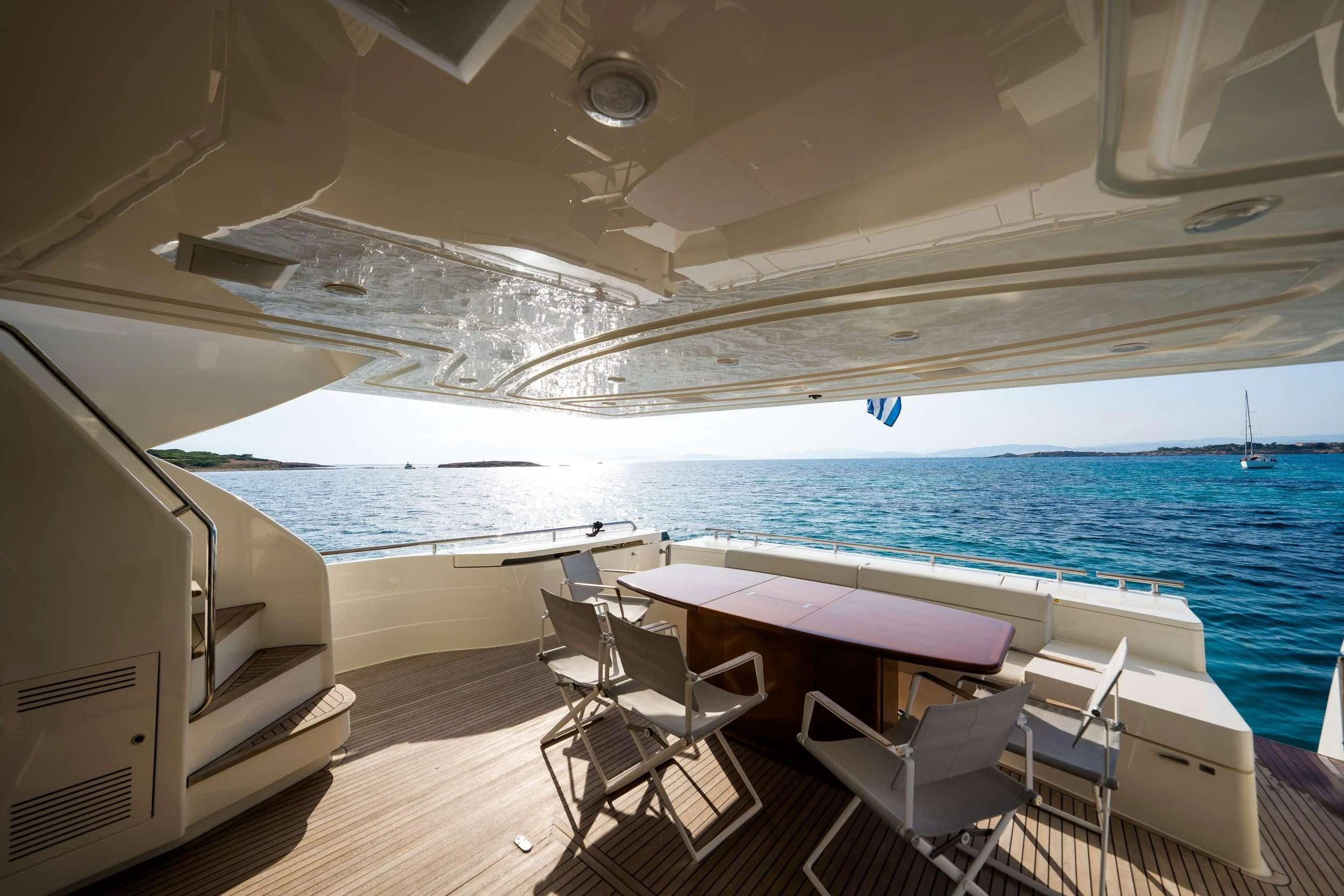 a boat with a table and chairs on the deck aboard NINETEEN Yacht for Charter