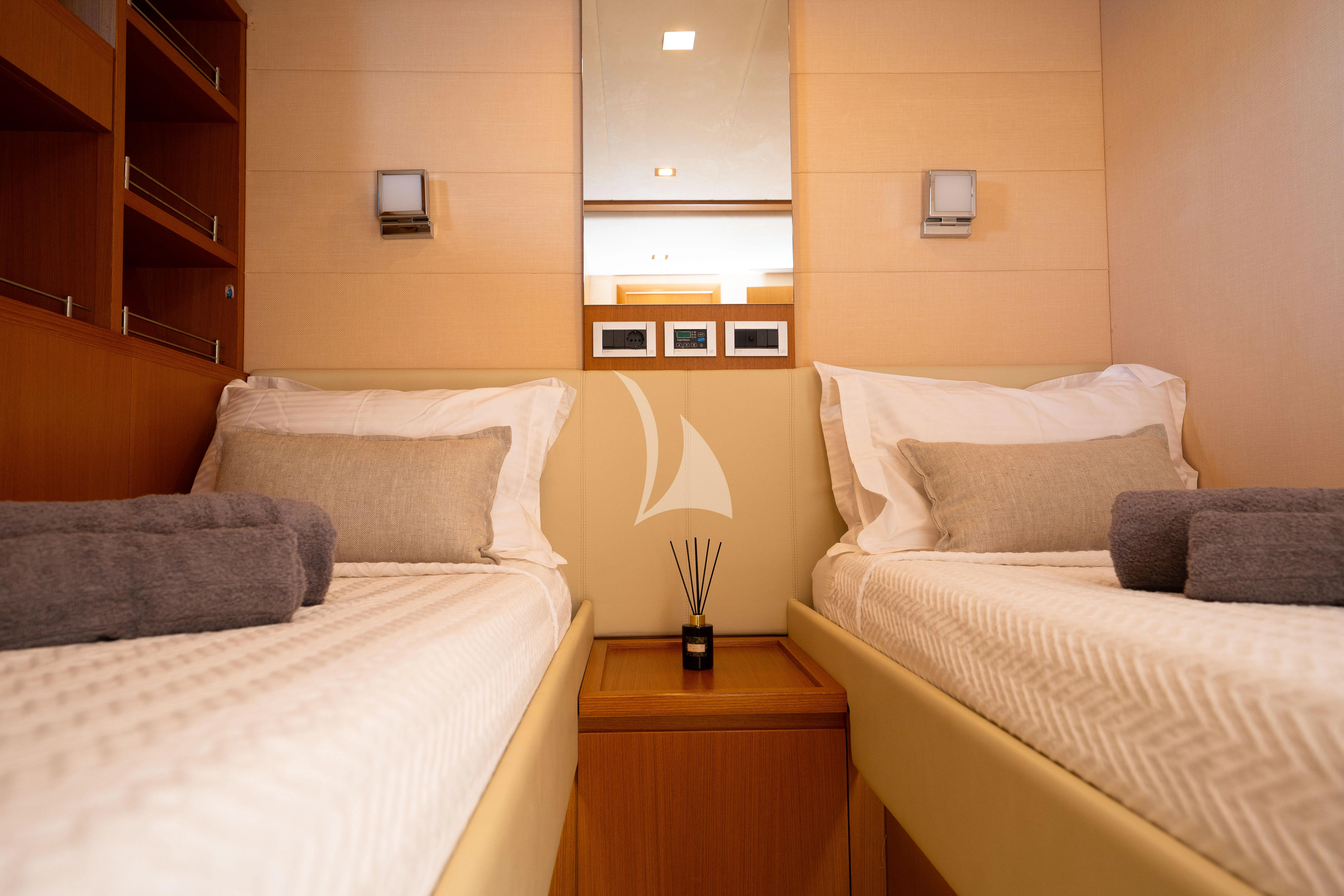 a room with two beds aboard NINETEEN Yacht for Charter