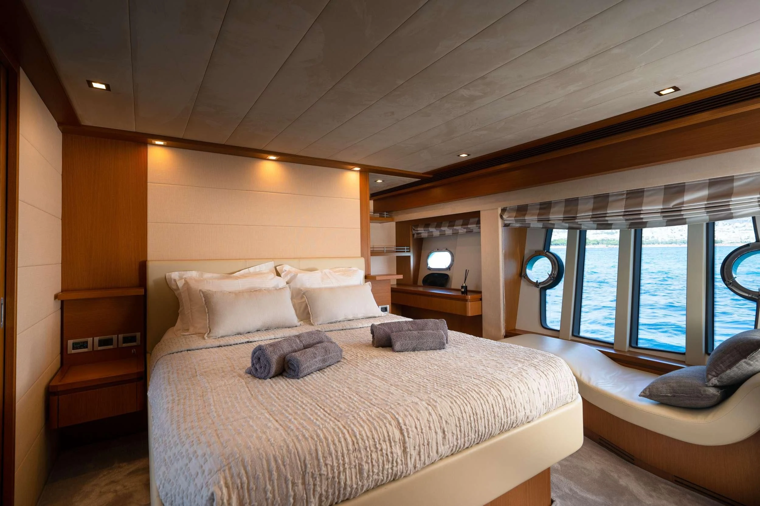 a bedroom with a bed and a window aboard NINETEEN Yacht for Charter