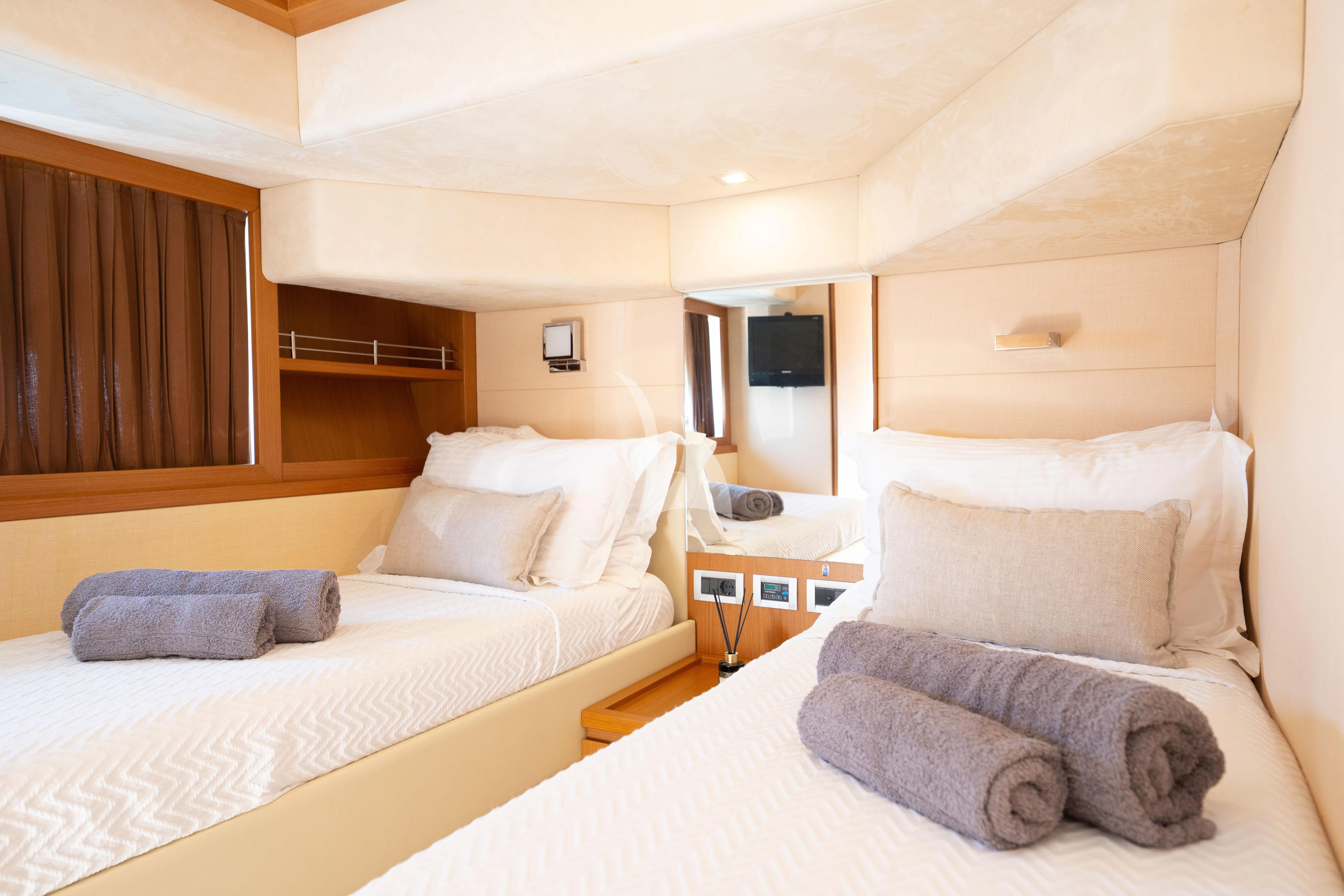 a room with two beds aboard NINETEEN Yacht for Charter