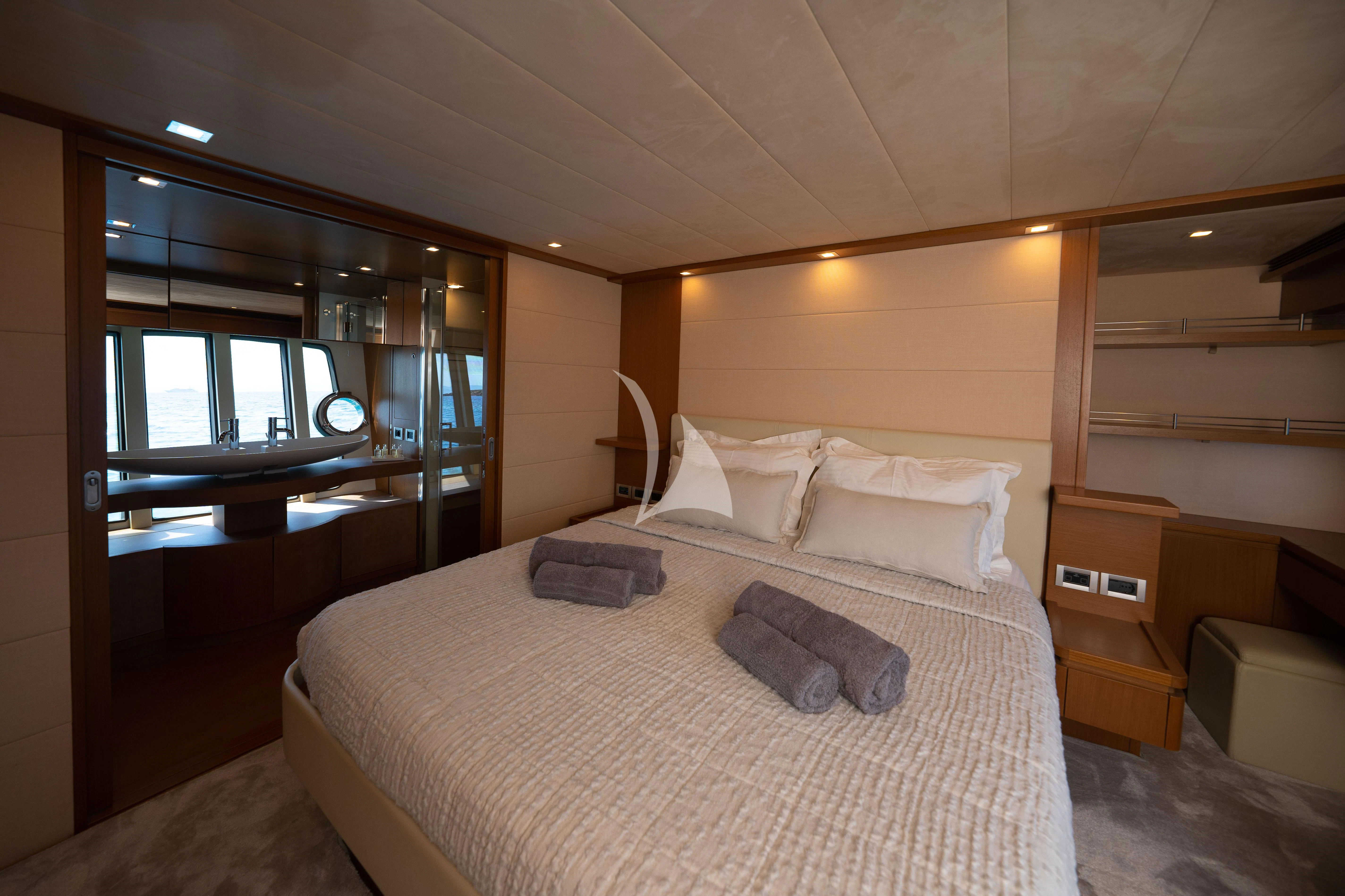 a bed with white sheets aboard NINETEEN Yacht for Charter