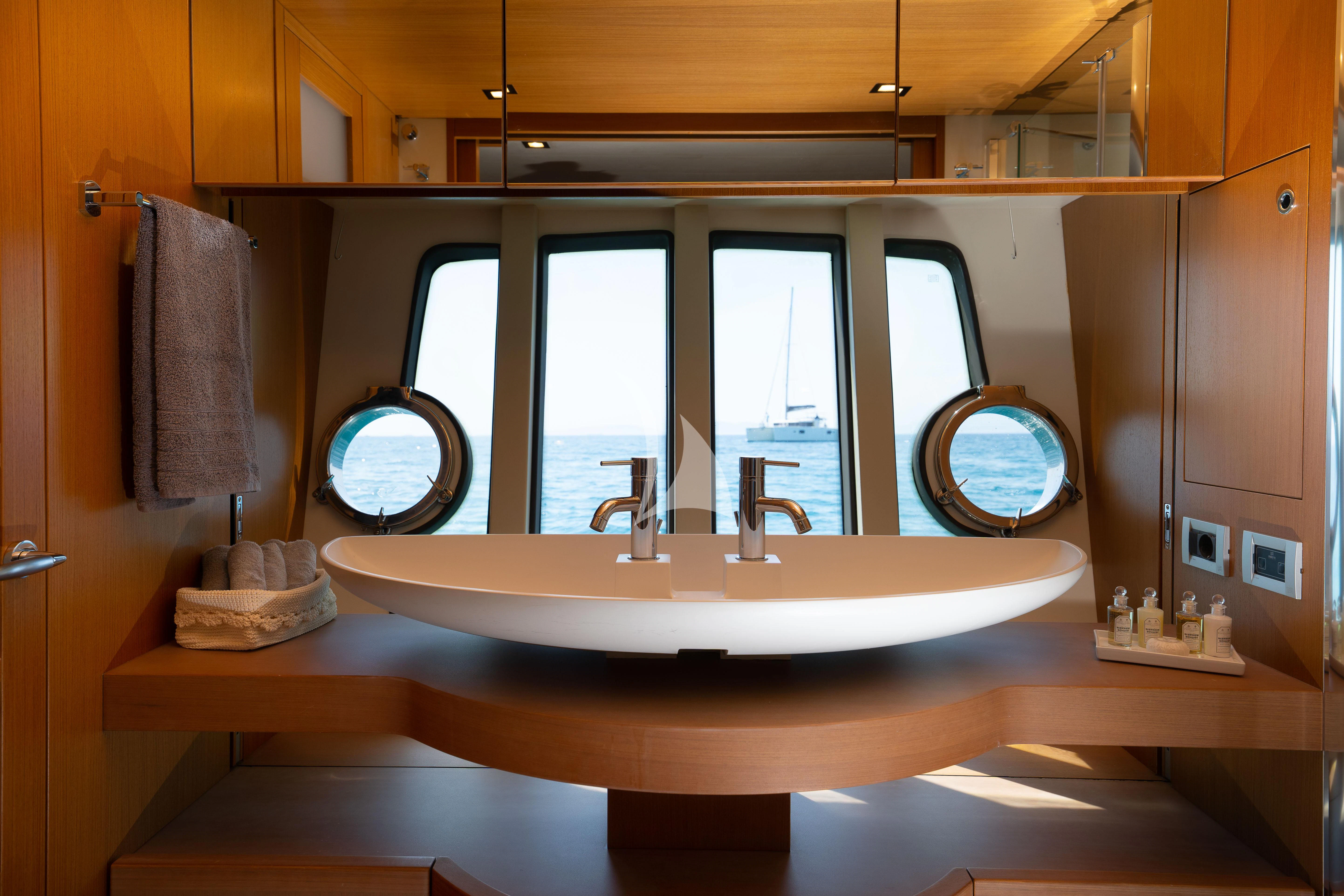 a bathroom with a large mirror aboard NINETEEN Yacht for Charter