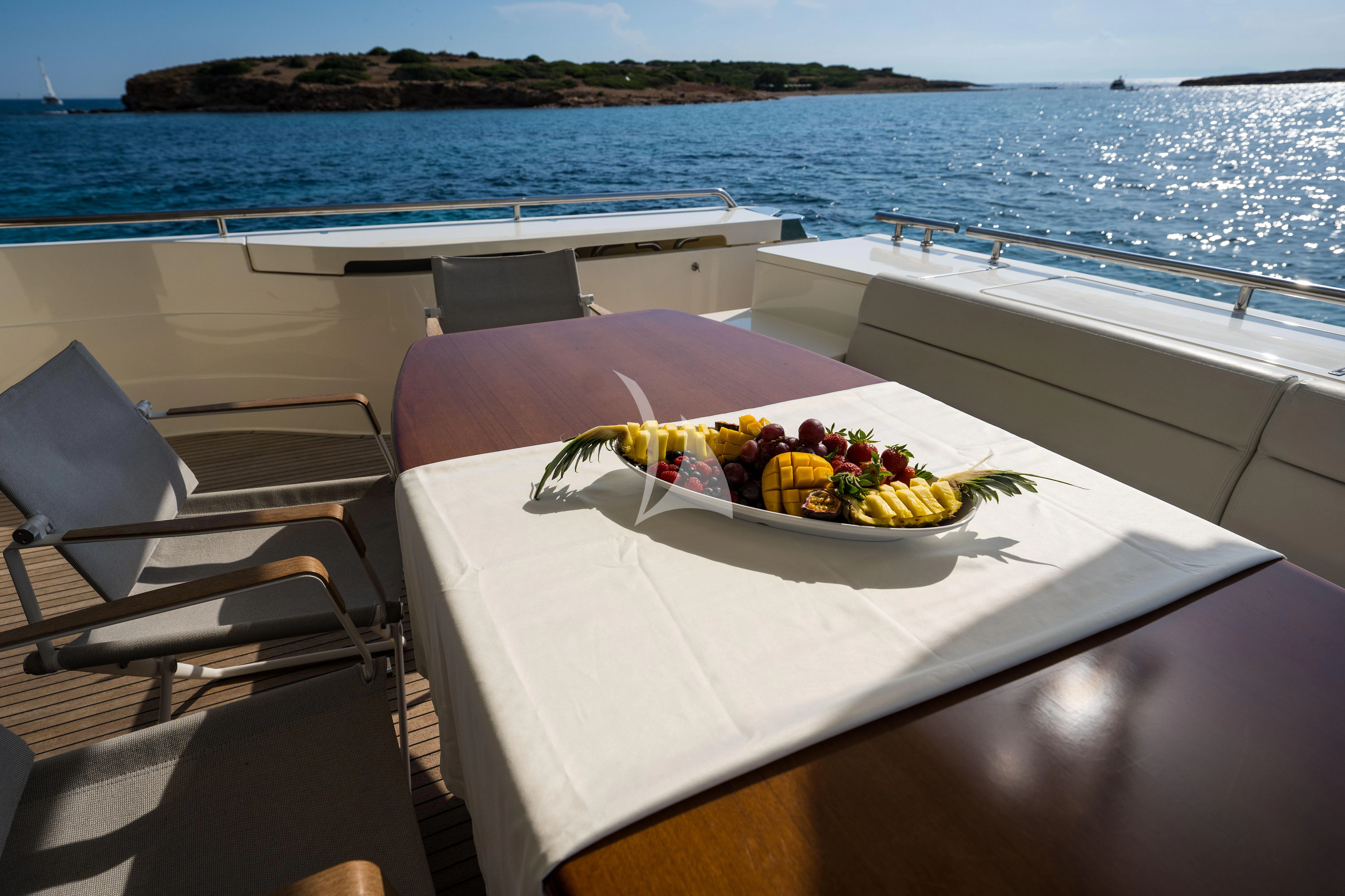 a table with fruit on it on a boat aboard NINETEEN Yacht for Charter