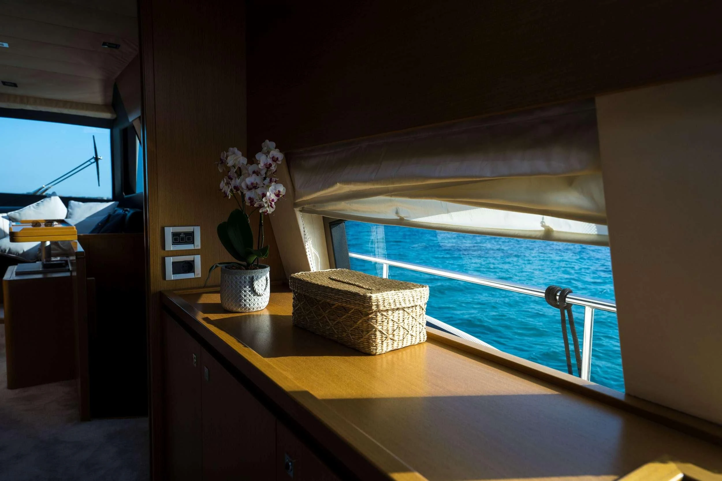 a room with a table and a window aboard NINETEEN Yacht for Charter