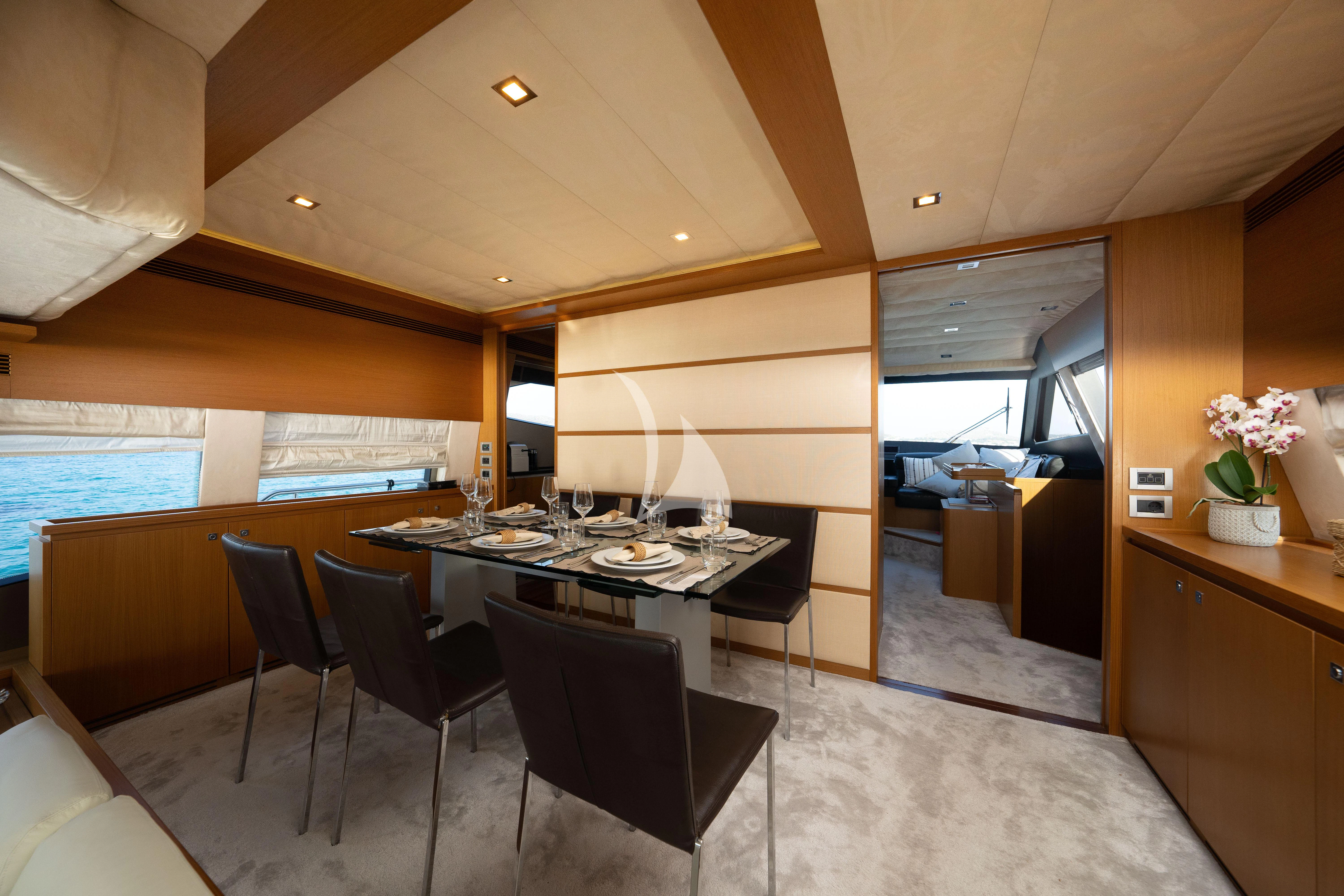 a large dining table in a room aboard NINETEEN Yacht for Charter