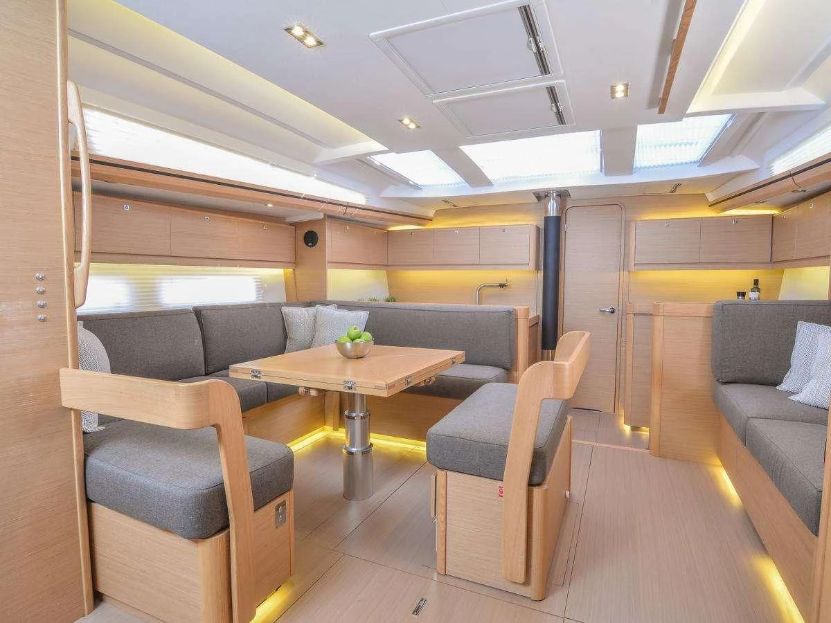 a room with a table and chairs aboard NINETEEN Yacht for Charter