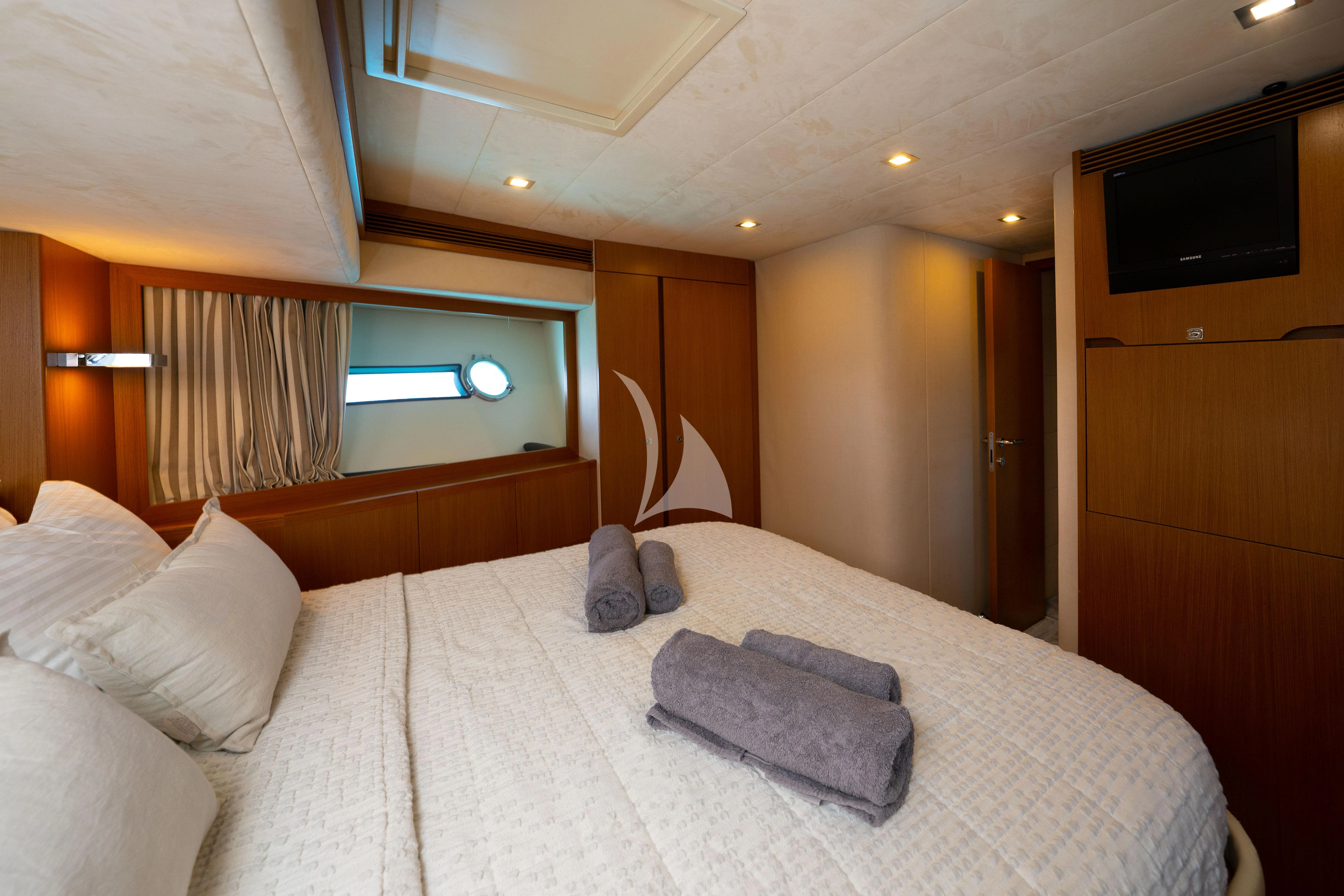 a bed with a white sheet and pillows aboard NINETEEN Yacht for Charter