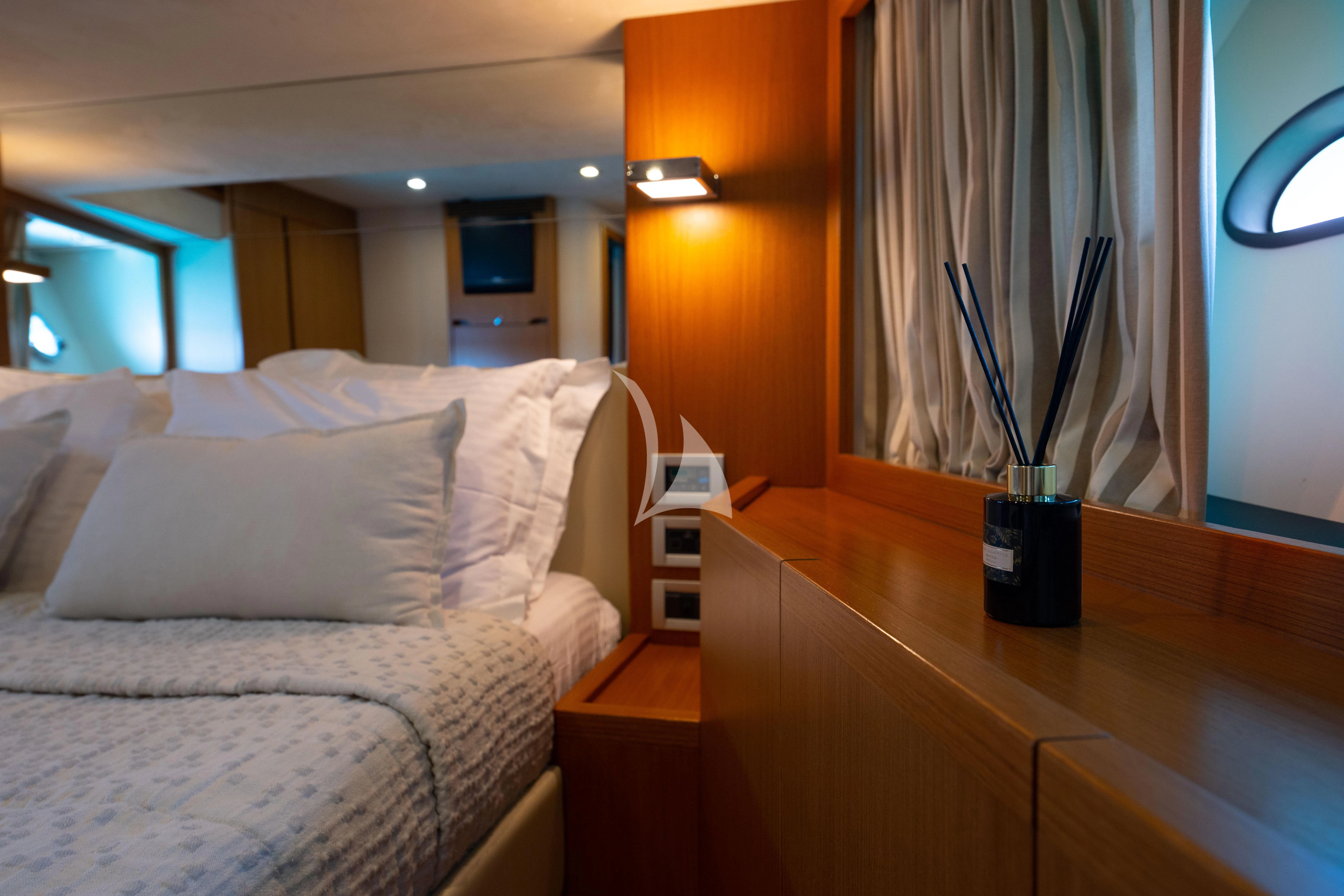 a bed with a plant on the end aboard NINETEEN Yacht for Charter