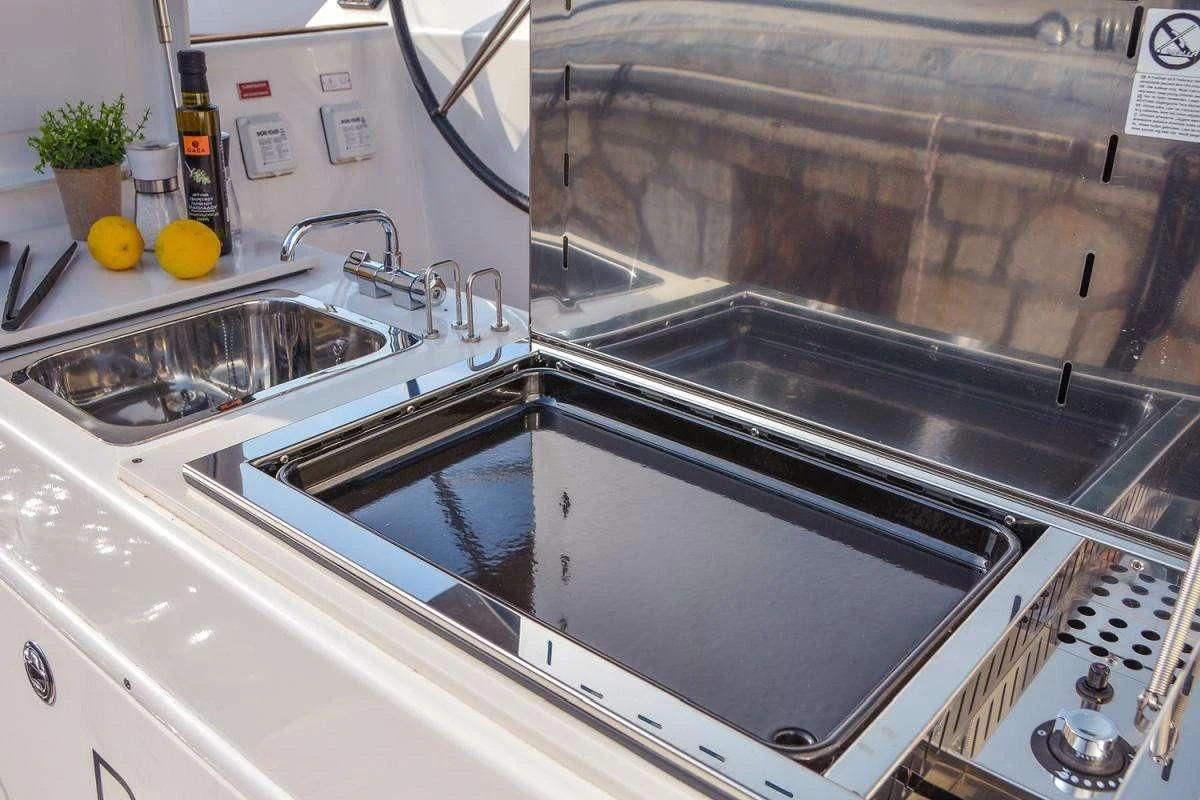 a kitchen with a stainless steel oven aboard NINETEEN Yacht for Charter