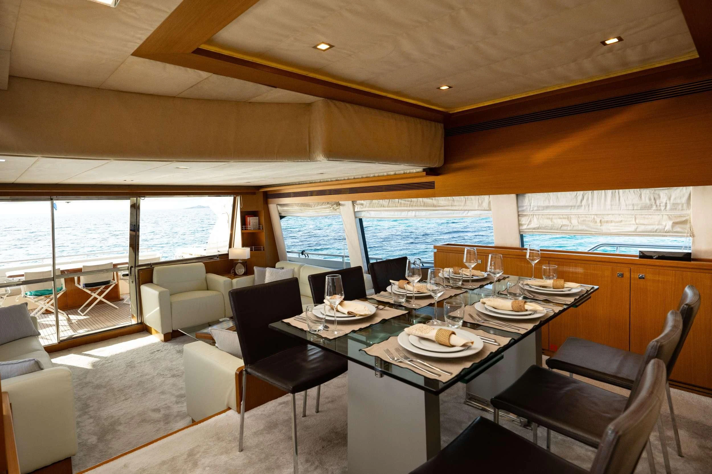 a dining room with a large window aboard NINETEEN Yacht for Charter