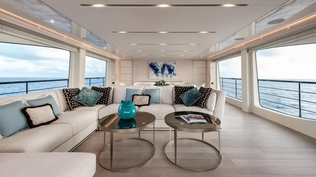 a living room with a couch and a coffee table aboard KIMOJO Yacht for Sale