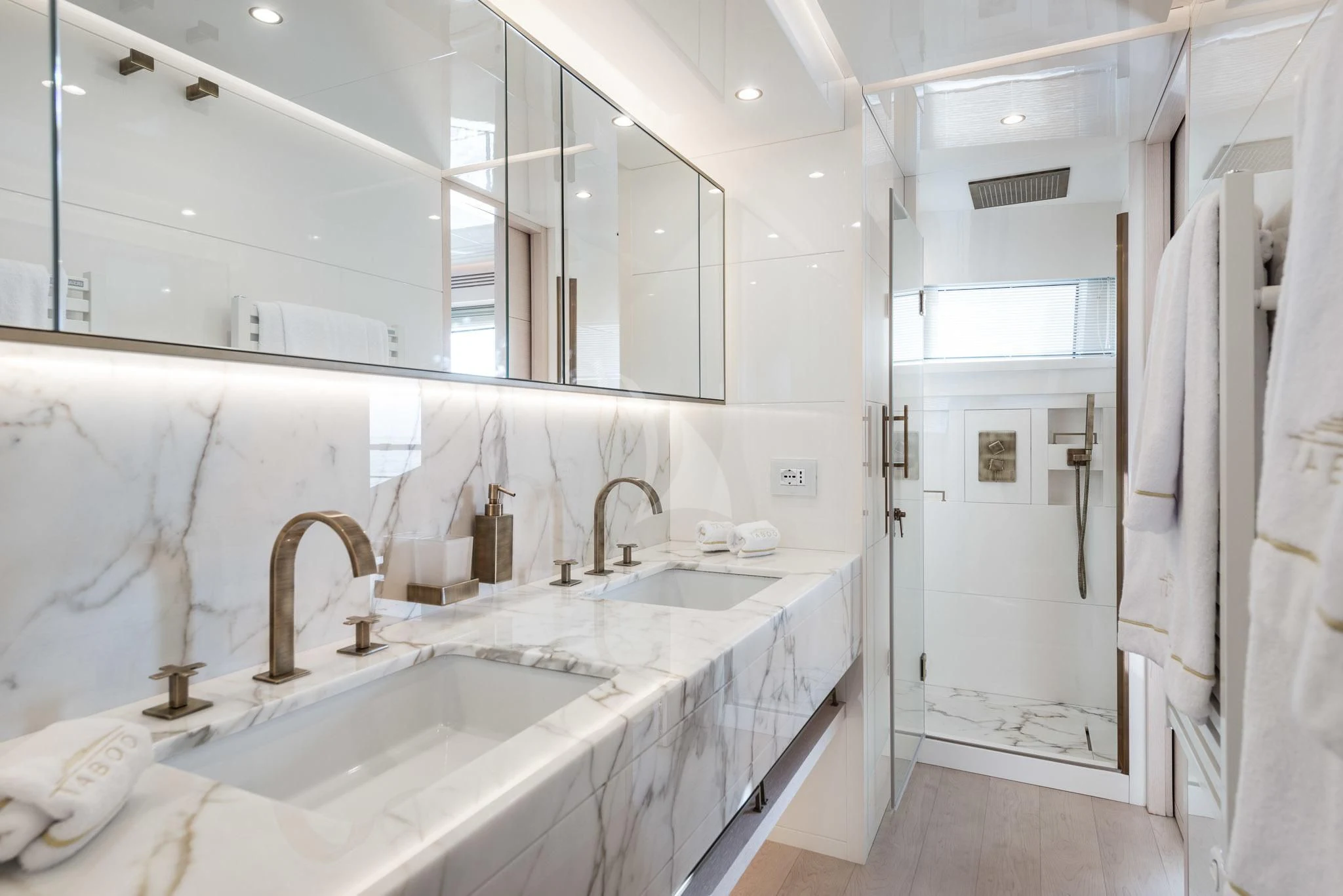 a bathroom with a large mirror aboard KIMOJO Yacht for Sale