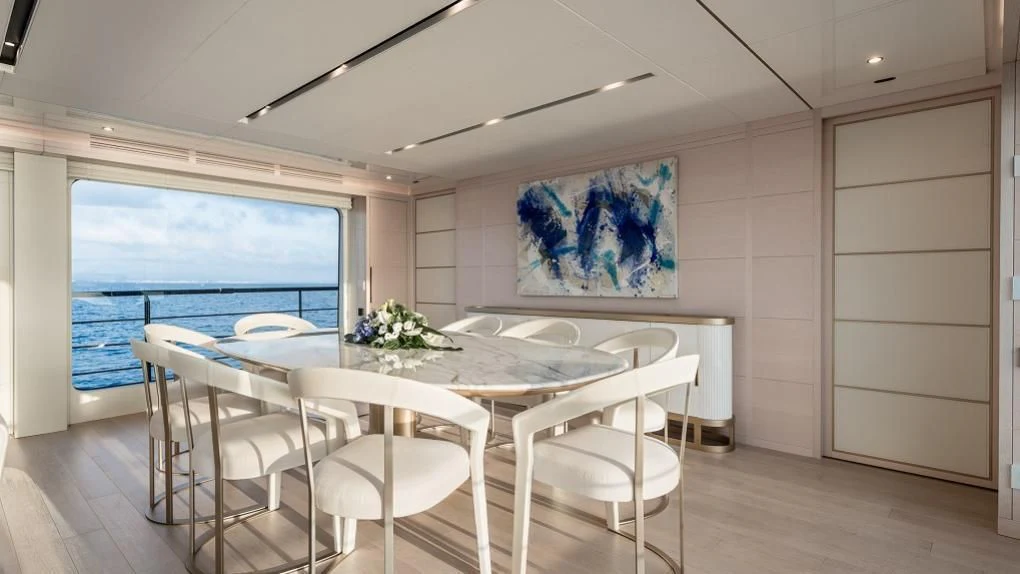 a room with a table and chairs aboard KIMOJO Yacht for Sale