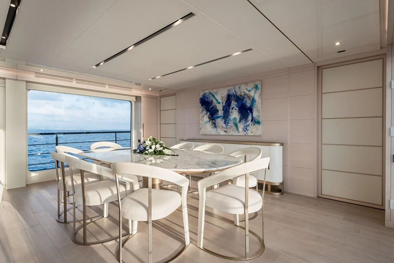 a large room with a table and chairs aboard KIMOJO Yacht for Sale