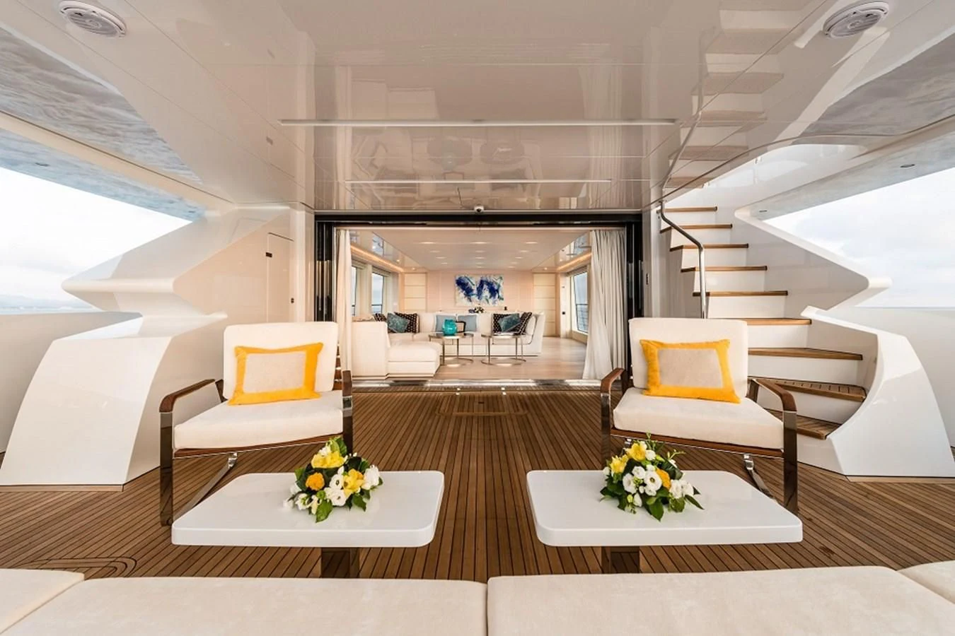 a room with a table chairs and a couch aboard KIMOJO Yacht for Sale