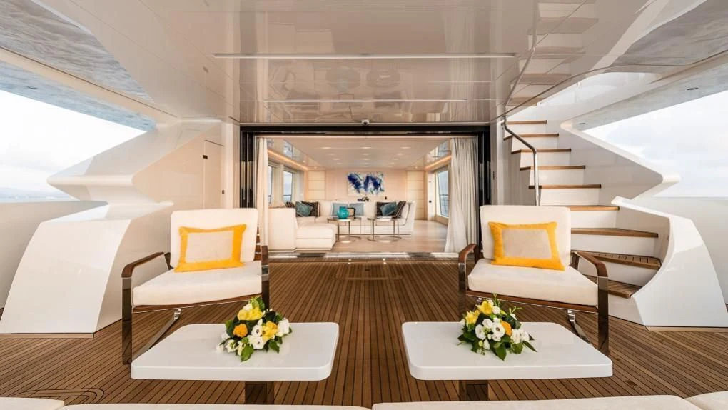 a room with a table chairs and a staircase aboard KIMOJO Yacht for Sale