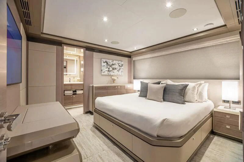 a room with a bed and a desk aboard NIRVANA II Yacht for Sale
