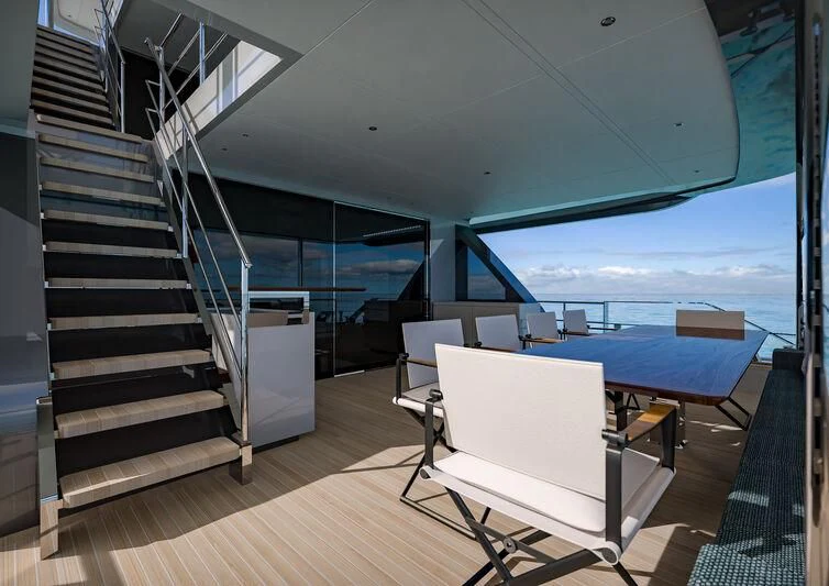 a room with a table and chairs aboard NIRVANA II Yacht for Sale