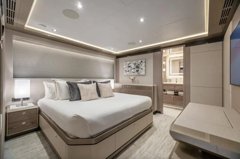 a bedroom with a bed and a mirror aboard NIRVANA II Yacht for Sale