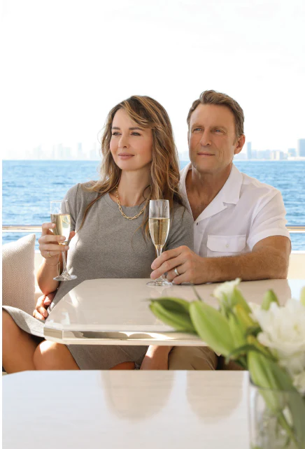Chris Charles et al. holding wine glasses aboard NIRVANA II Yacht for Sale