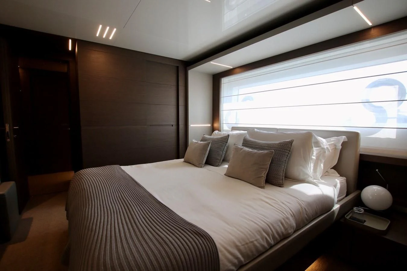 a bed with a white bed spread aboard WILLPOWER Yacht for Sale