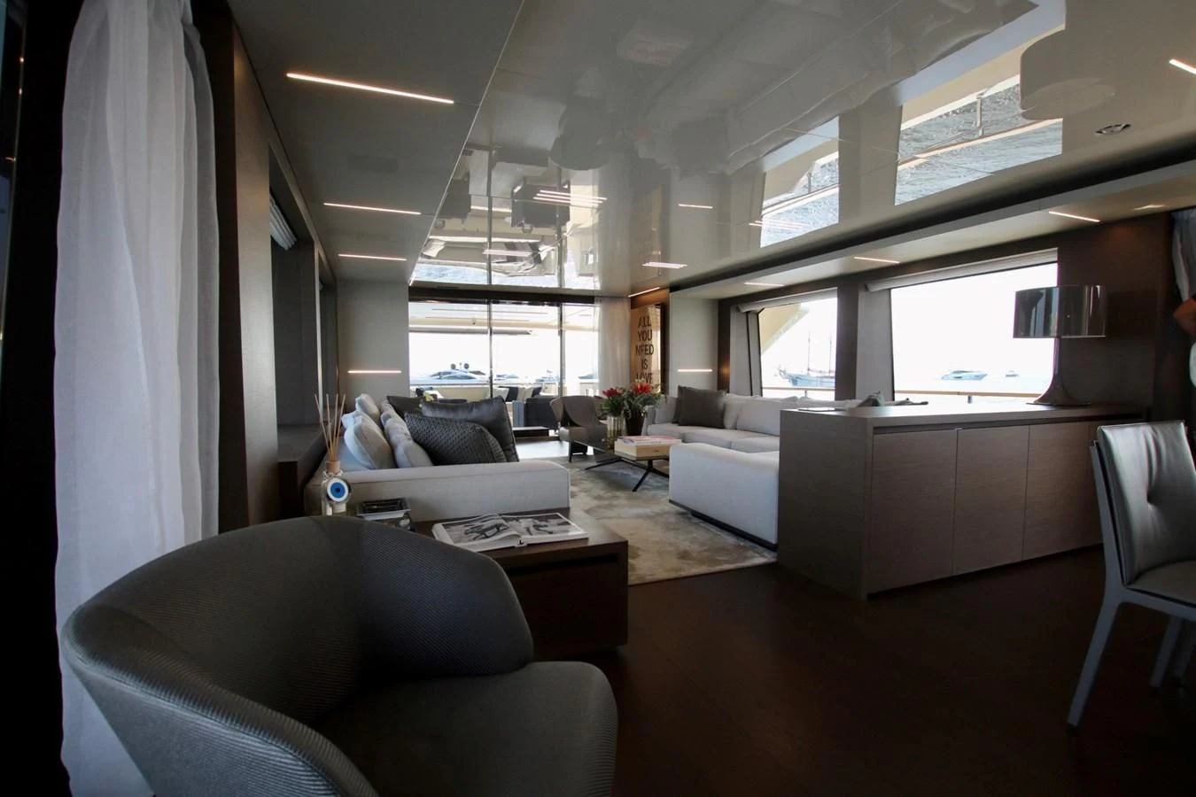 a living room with white furniture aboard WILLPOWER Yacht for Sale