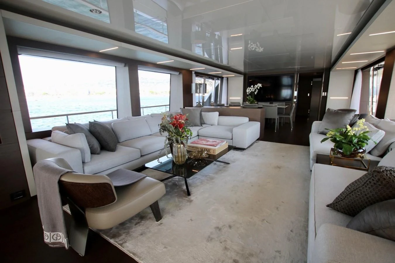 a living room with white furniture aboard WILLPOWER Yacht for Sale