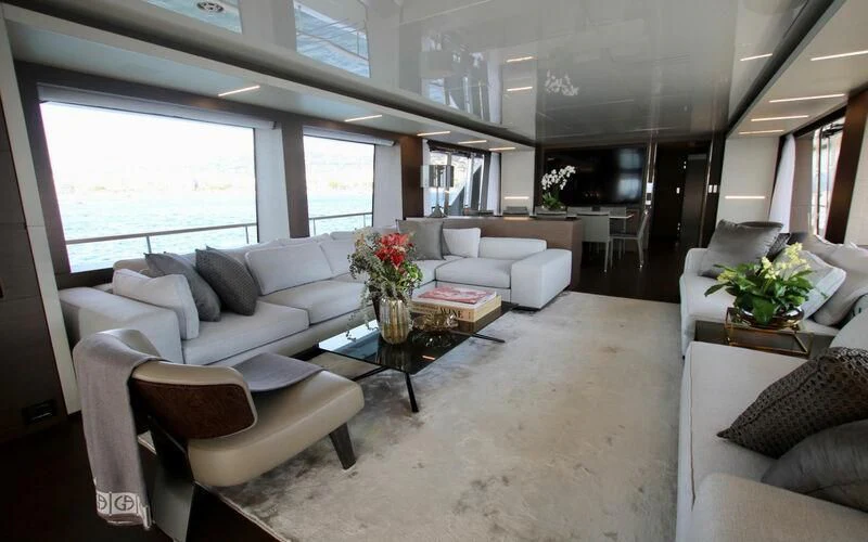 a living room with white couches aboard WILLPOWER Yacht for Sale