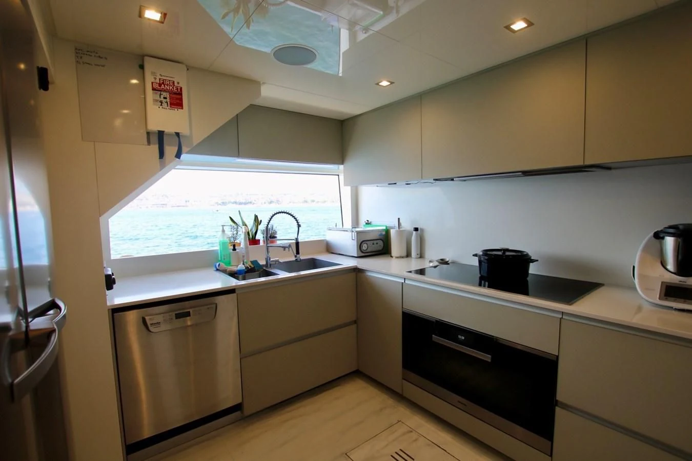 a kitchen with white cabinets aboard WILLPOWER Yacht for Sale