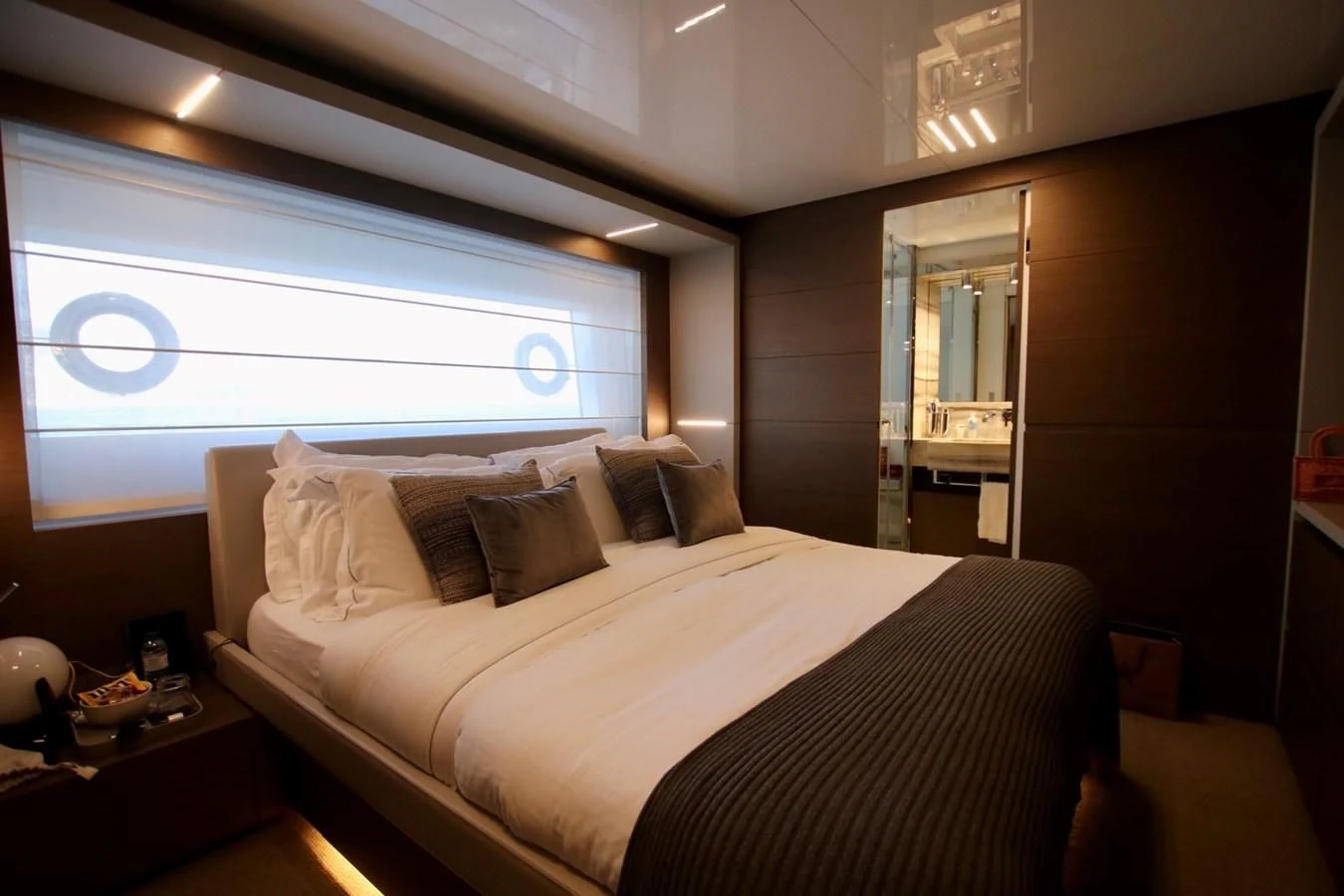 a bed with a white bed spread aboard WILLPOWER Yacht for Sale