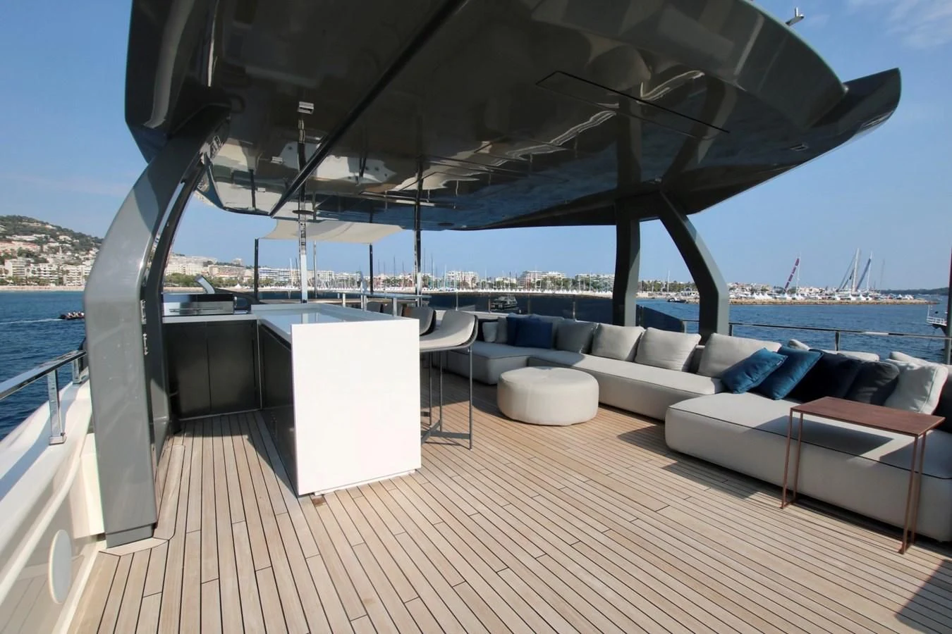 a large lounge chair on a deck overlooking a body of water aboard WILLPOWER Yacht for Sale