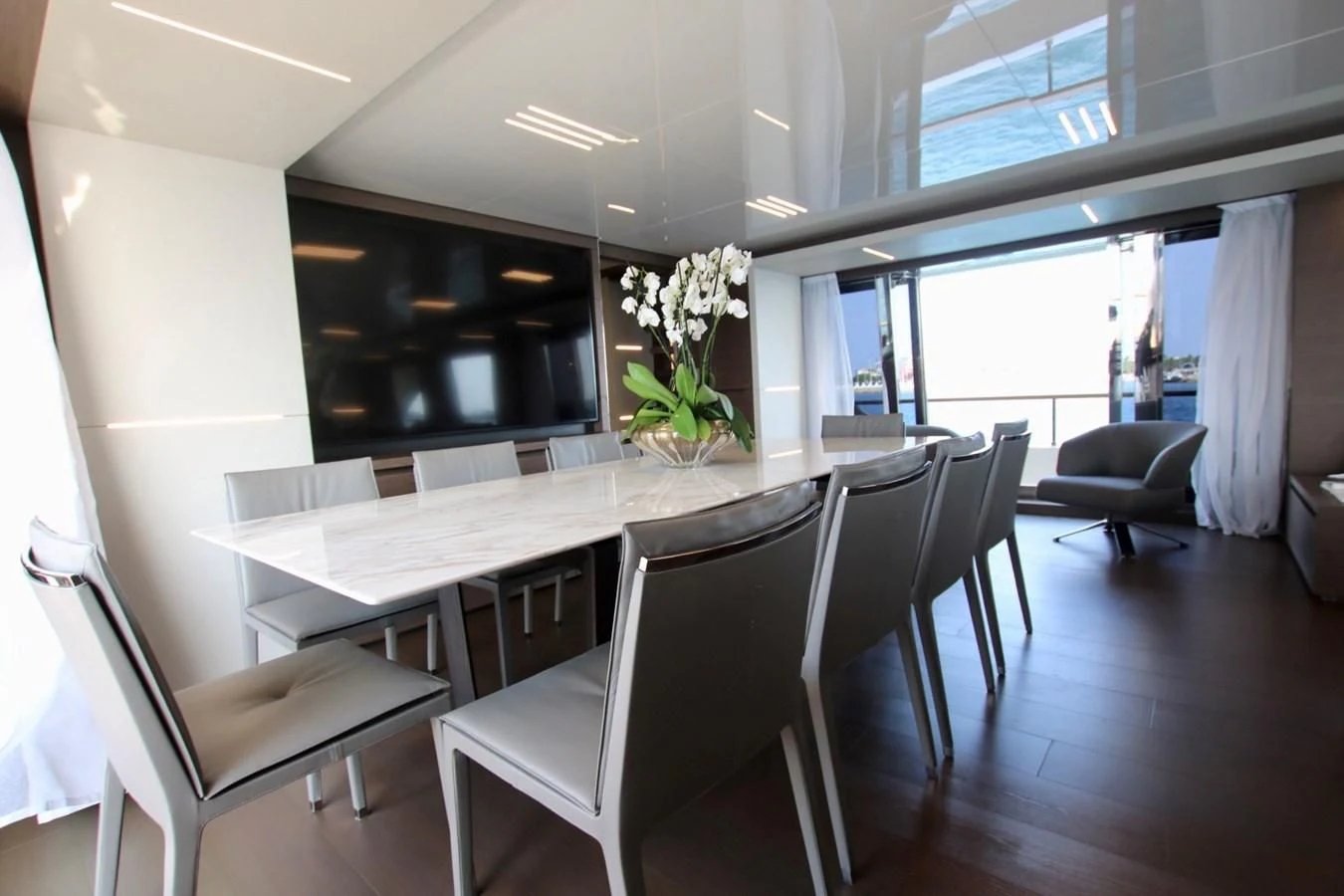 a room with a table chairs and a plant in it aboard WILLPOWER Yacht for Sale