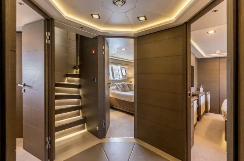 a room with a bed and a door aboard MANTA Yacht for Sale