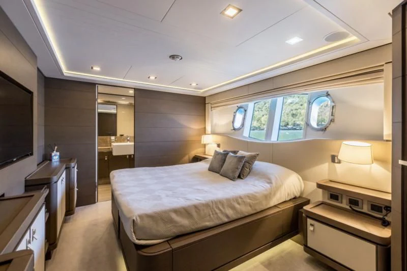 a bedroom with a large bed aboard MANTA Yacht for Sale