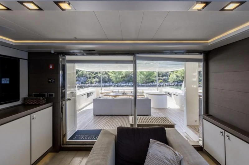 a room with a couch and a table and a tv aboard MANTA Yacht for Sale