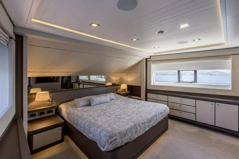 a room with a bed and a desk aboard MANTA Yacht for Sale