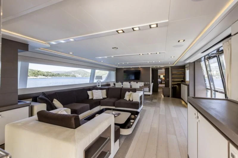 a room with couches and a table aboard MANTA Yacht for Sale