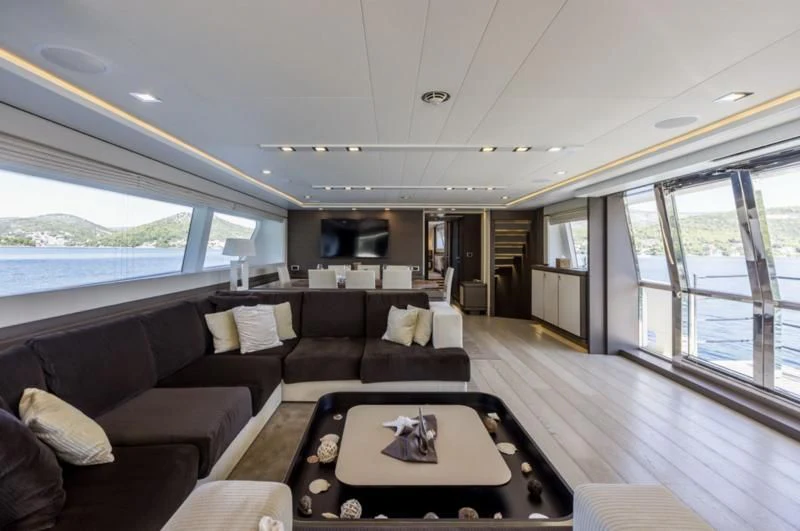 a living room with a large window aboard MANTA Yacht for Sale