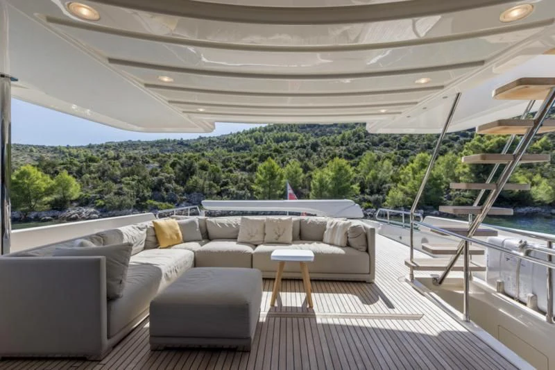 a large living room with a large window overlooking a forest aboard MANTA Yacht for Sale