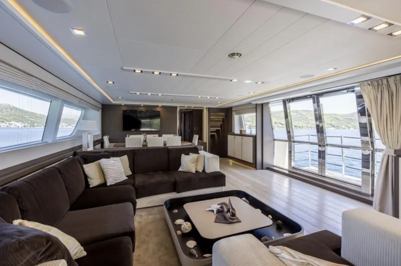 a living room with a large window aboard MANTA Yacht for Sale