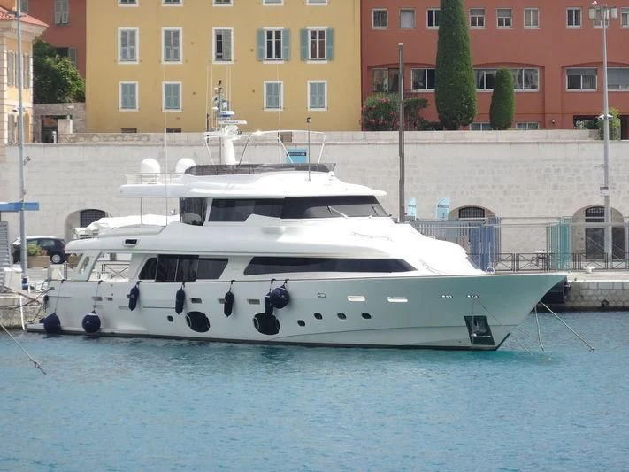 a white boat in a harbor aboard MANTA Yacht for Sale