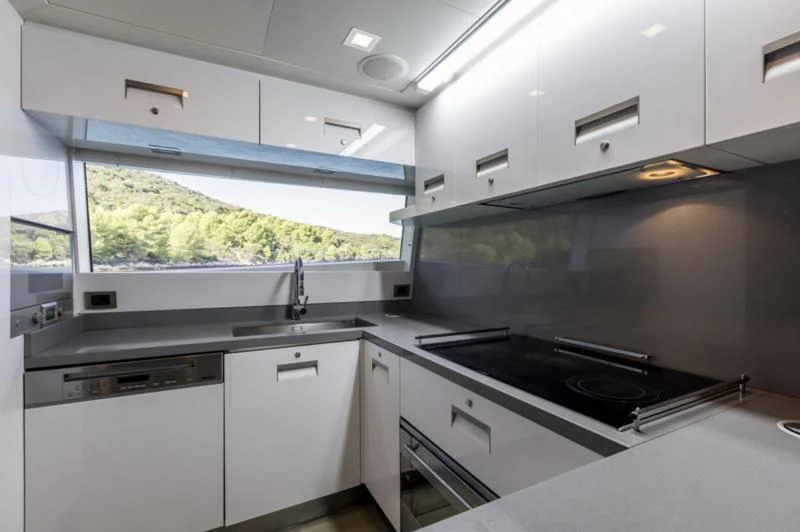 a kitchen with a stove and cabinets aboard MANTA Yacht for Sale
