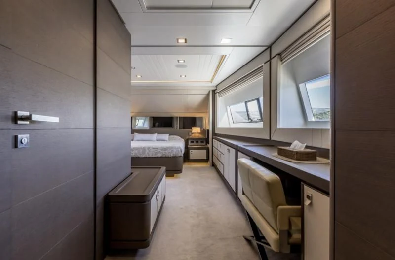 a room with a bed and a desk aboard MANTA Yacht for Sale