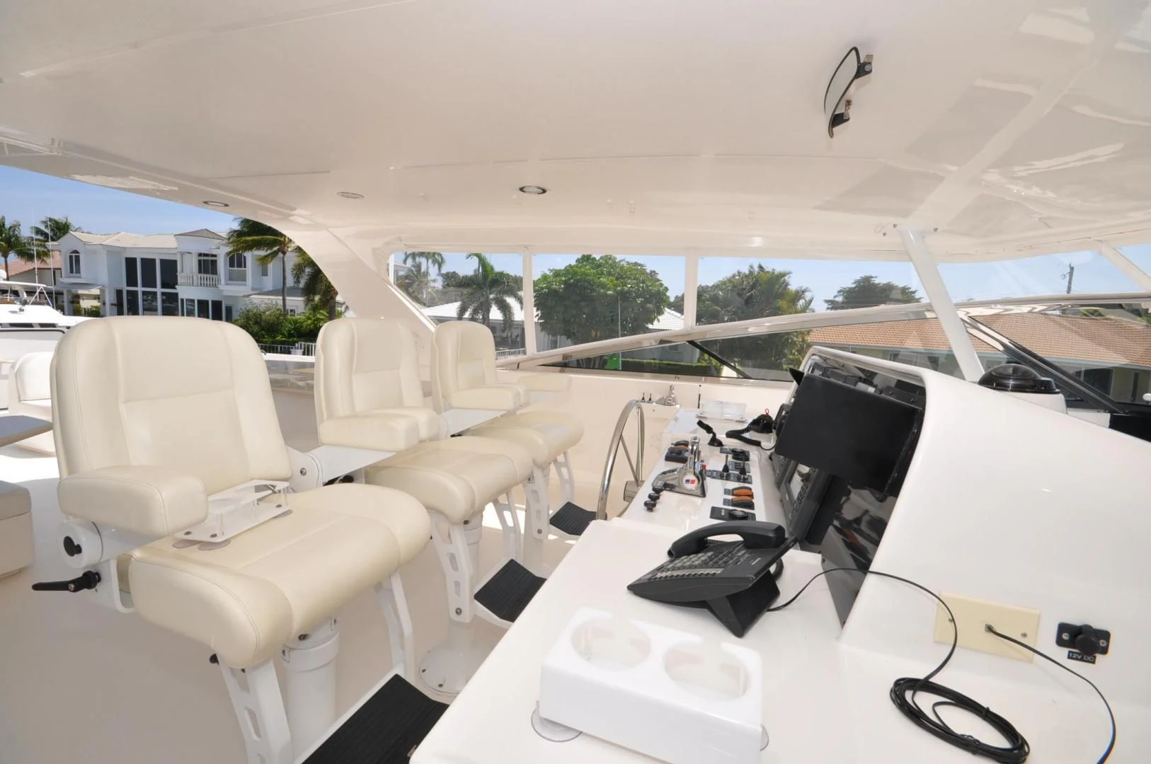 a white table with chairs and a computer on it aboard LUCK A LEE IV Yacht for Sale
