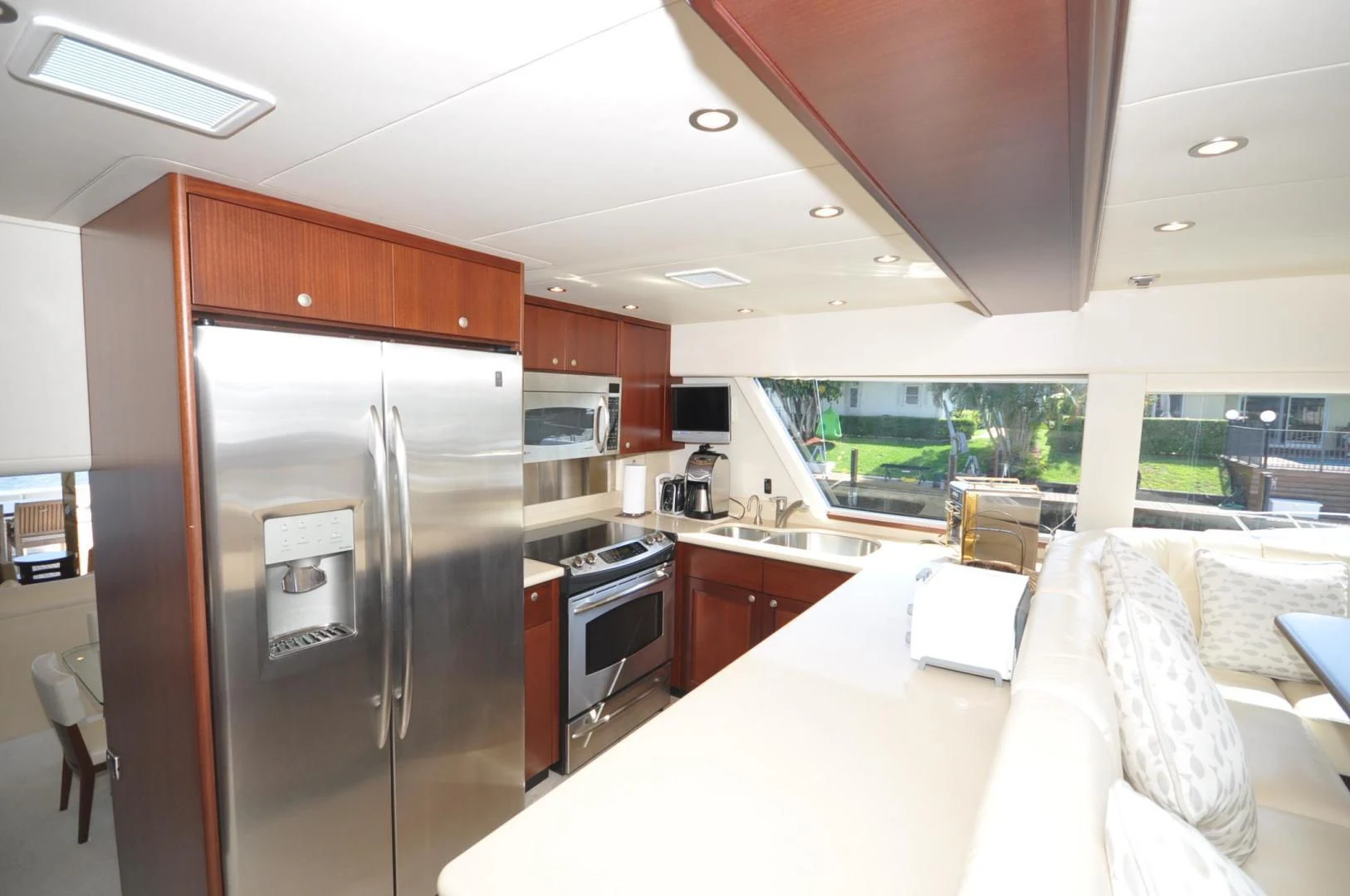 a kitchen with a refrigerator and a table aboard LUCK A LEE IV Yacht for Sale